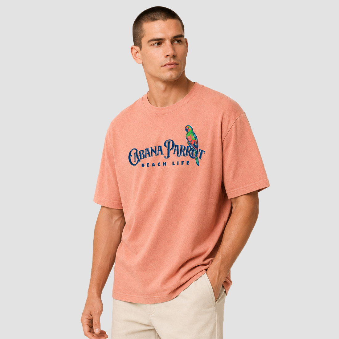Man wearing Cabana Parrot beach life tee with colorful parrot graphic, soft unisex beachwear